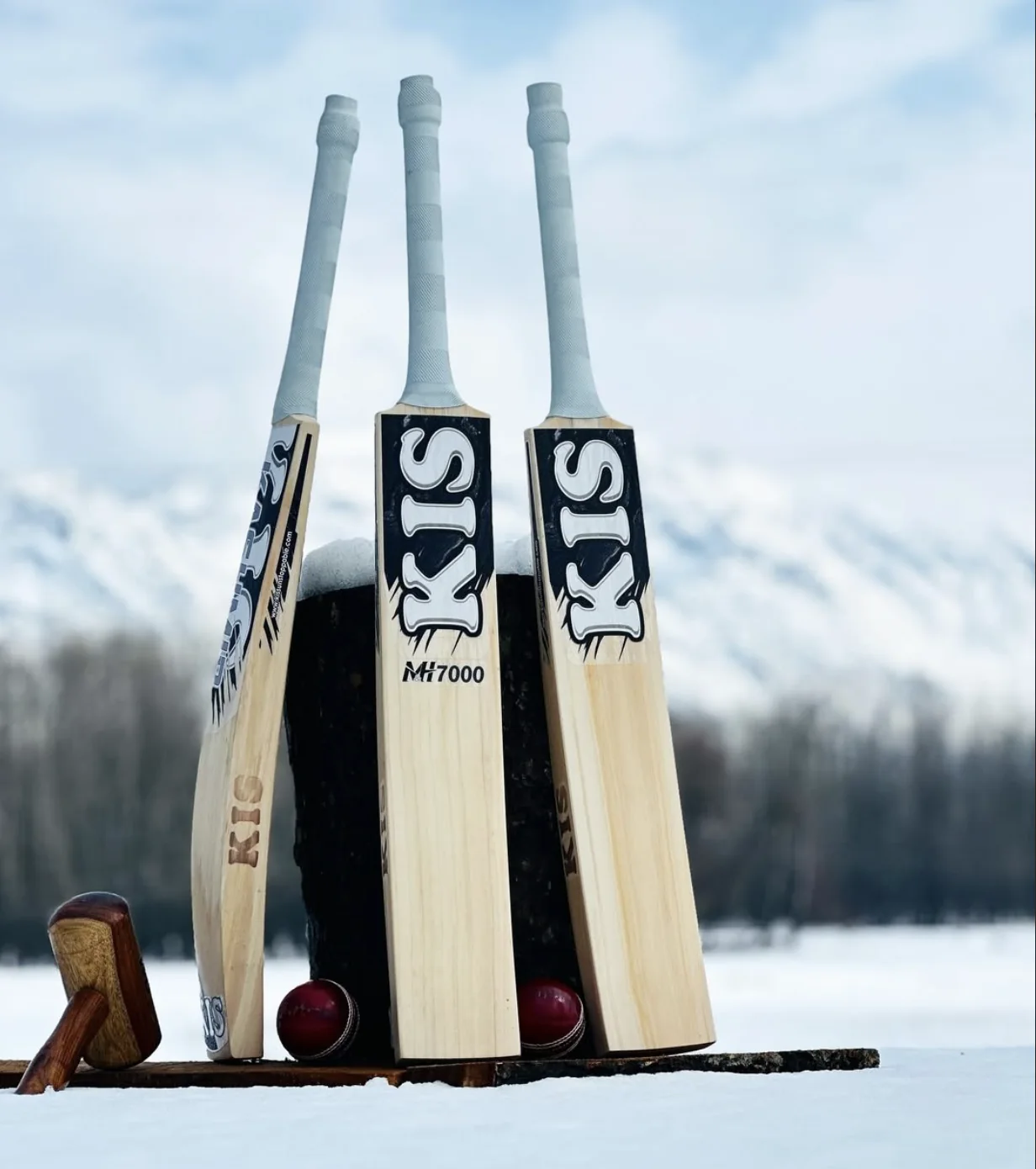 Three KIS M&H 7000 Kashmir willow bats standing in fresh snow below the Anantnag mountains